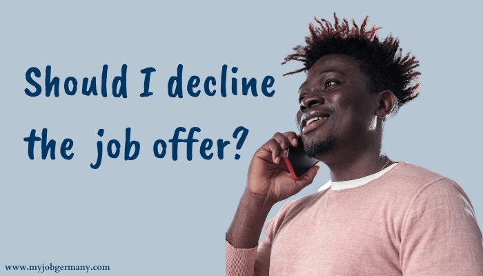 Student talking into a smartphone, asking if he should decline the job offer